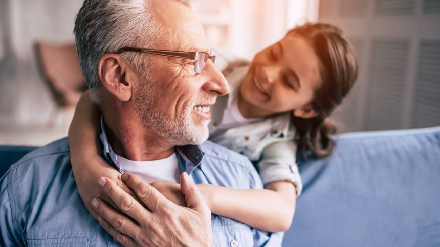 Grandfather with school aged granddaughter at home 