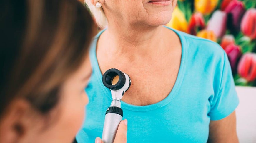 Seniors woman is examined by a dermatologist for skin cancer