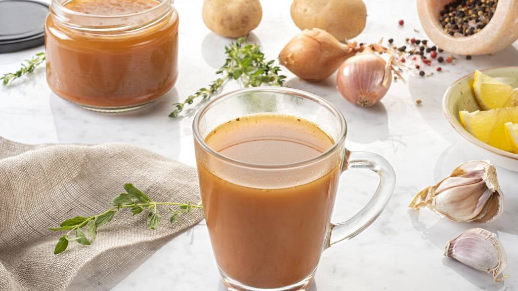 Organic bone broth in glass cups and jars