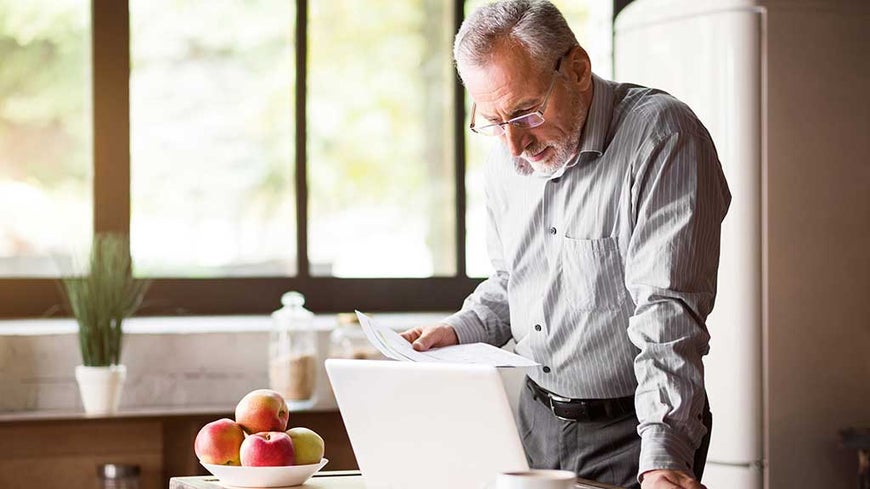 older man using laptop