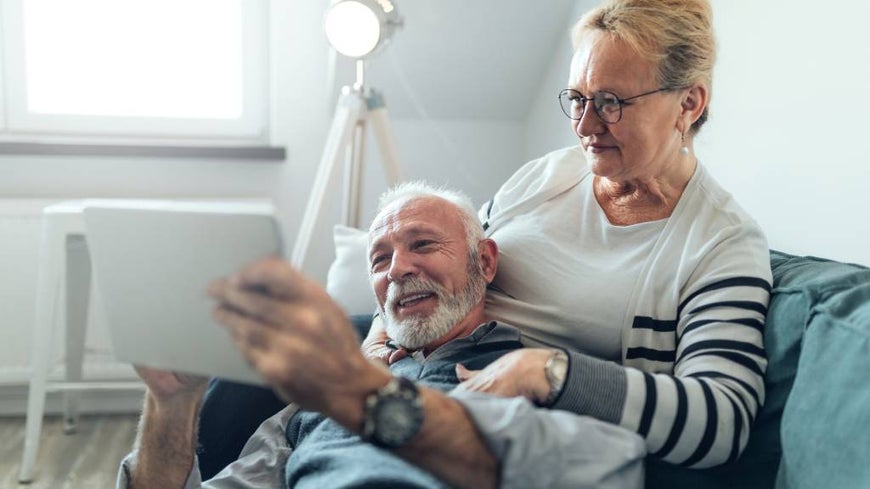 Older couple researching funeral costs