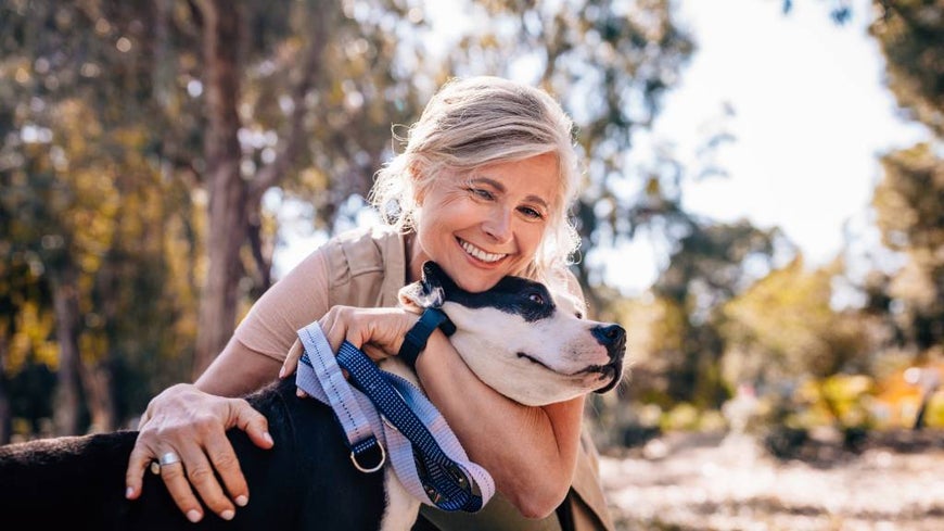 woman hugging older dog