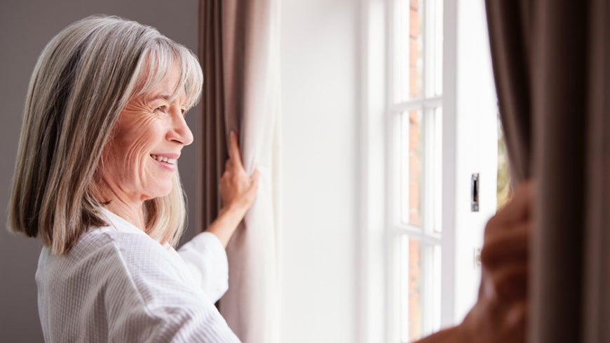 Older woman happy in her empty space at home