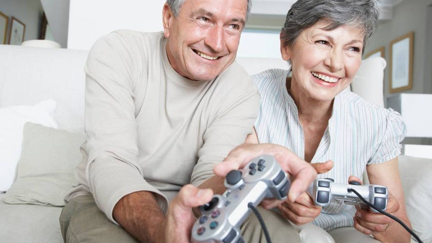 Senior couple plays games on Playstation