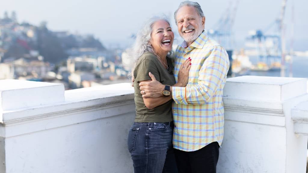A senior couple on a balcony in South America