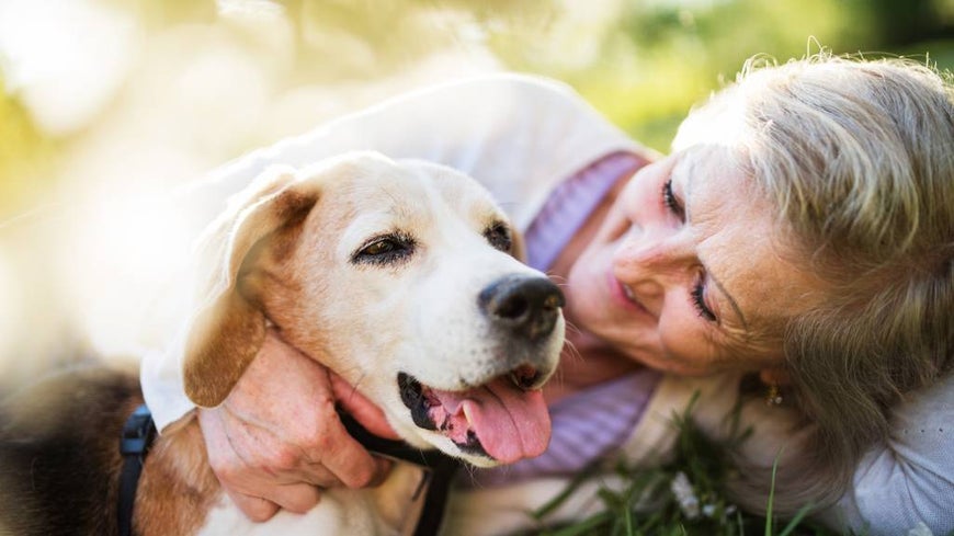 senior woman with dog outdoors