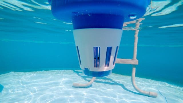 Floating pool tablet dispenser in pool 