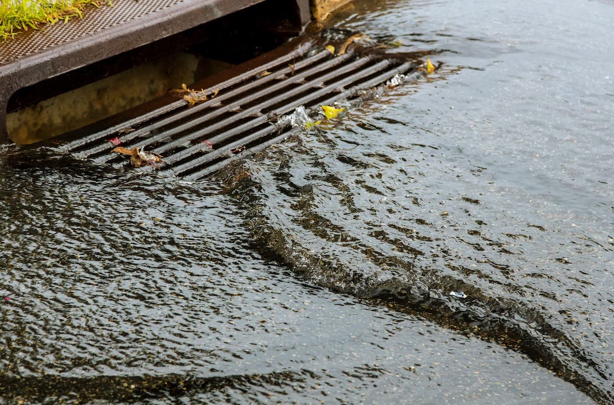 Heavy rain water going down a storm drain