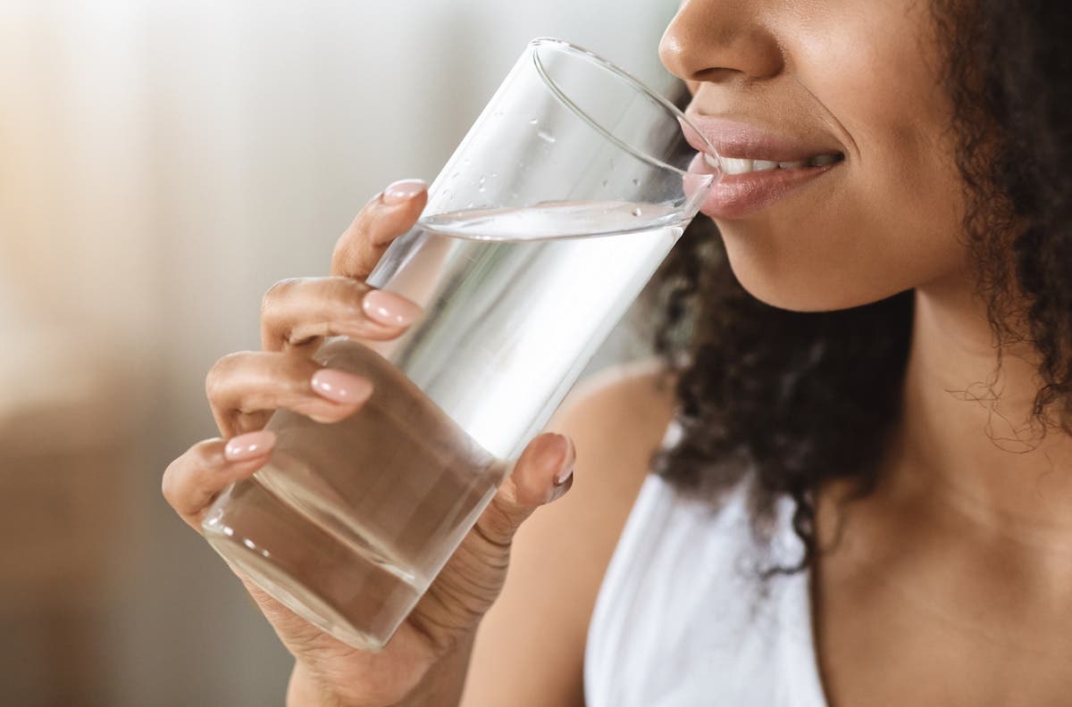 Lady drinking water from a glass 