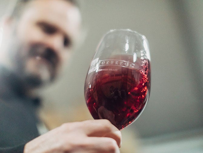 Ian Hongell swirling red wine in glass