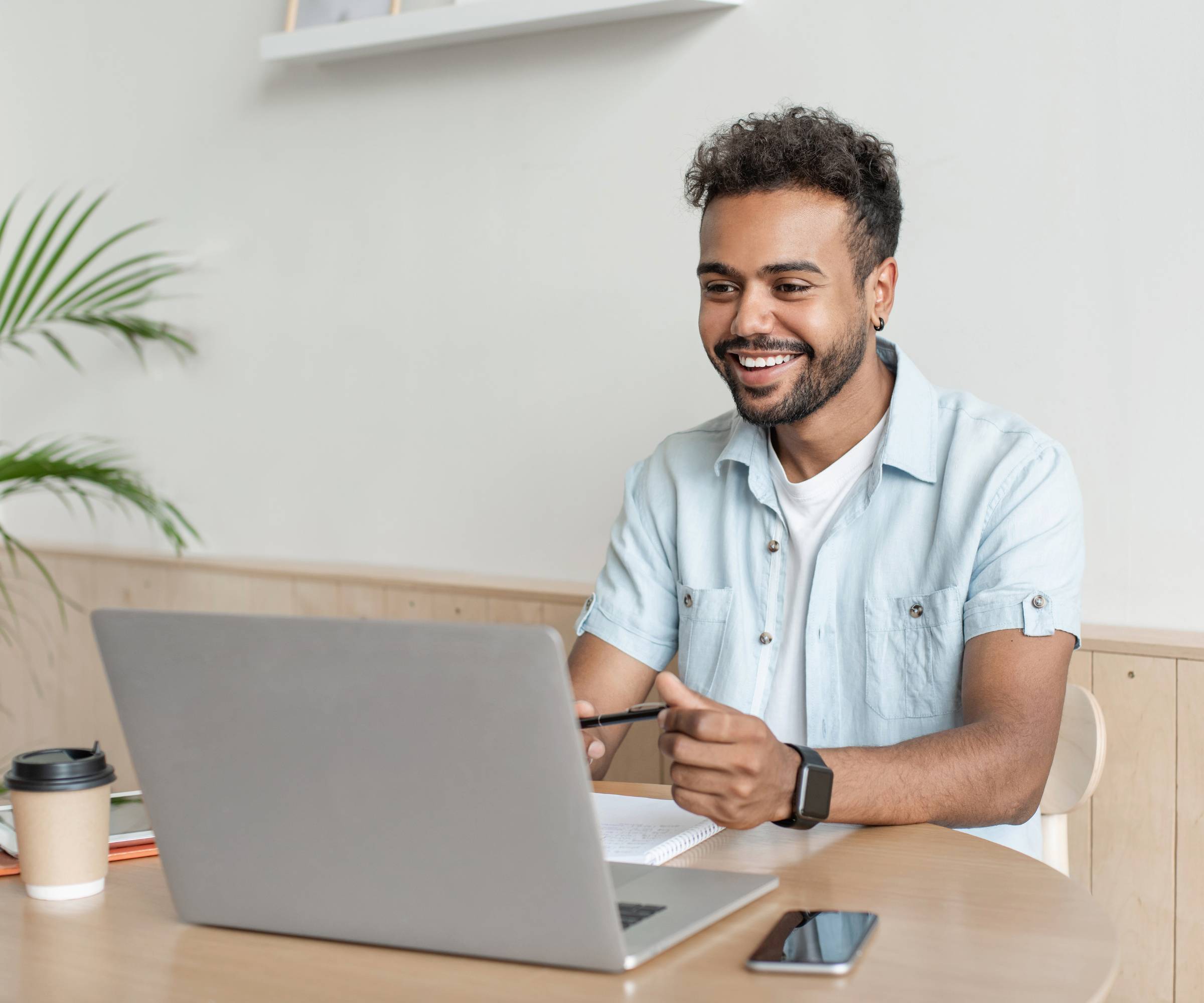 man enjoying online success on laptop