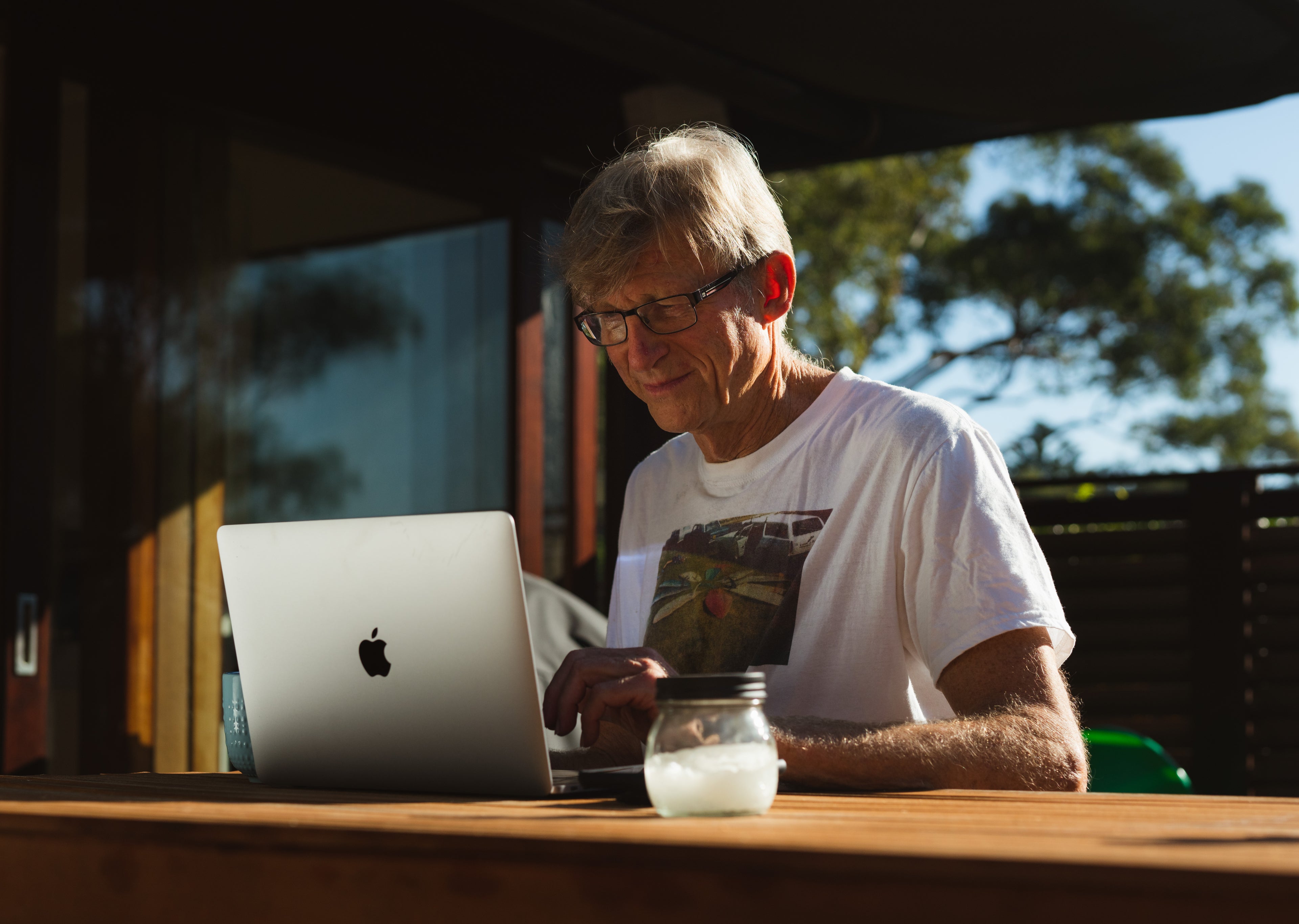 Older man at desk with laptop