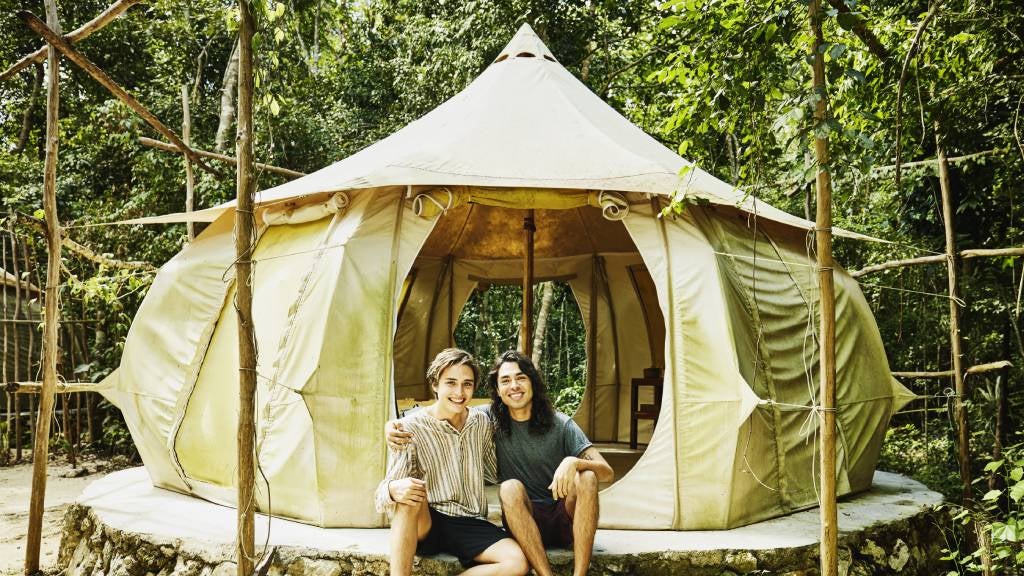 Couple glamping in a large canvas tent