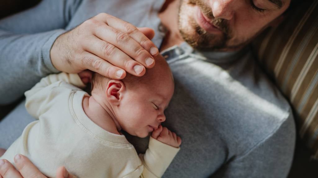 Father holds baby 