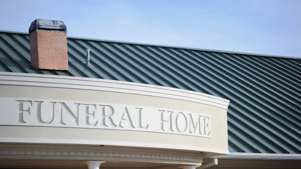 Exterior of a funeral home with carved lettering 