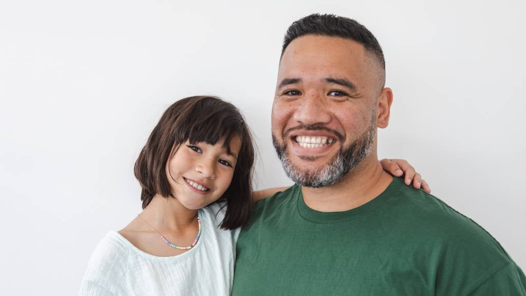 Dad and daughter smiling
