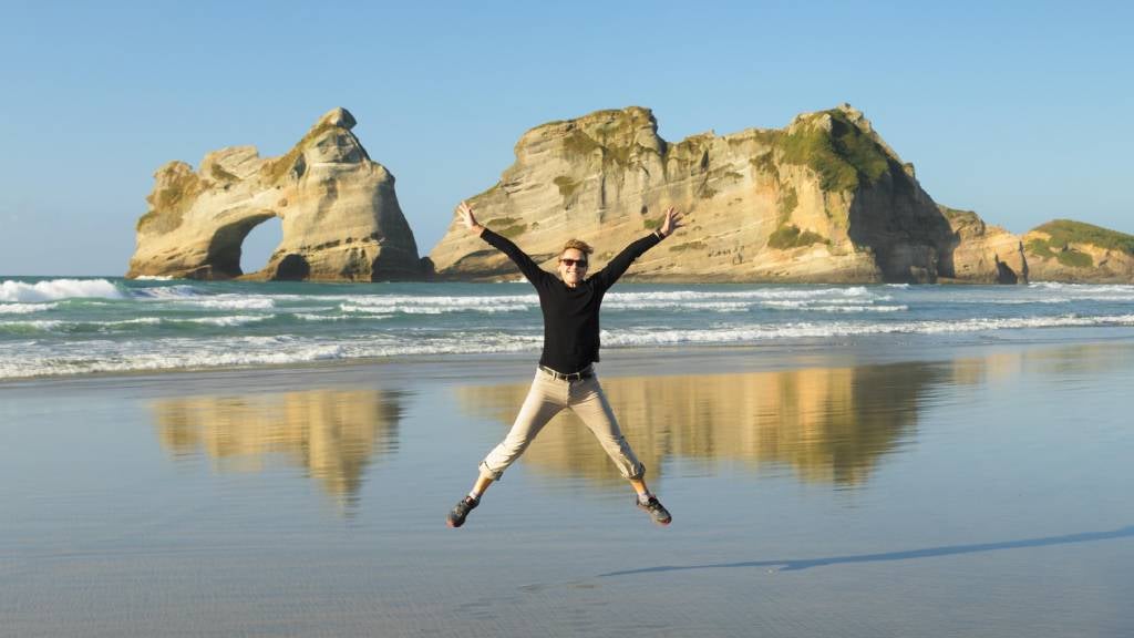 Man jumping at Wharariki Beach, Golden Bay