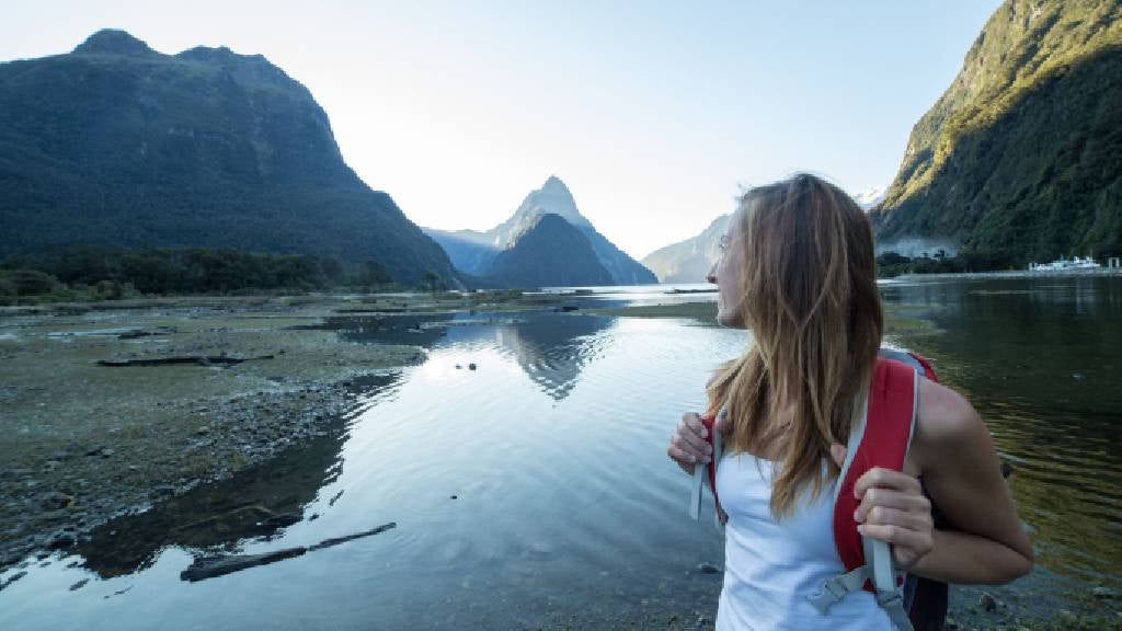 Young woman hiking in Milford Sound, New Zealand