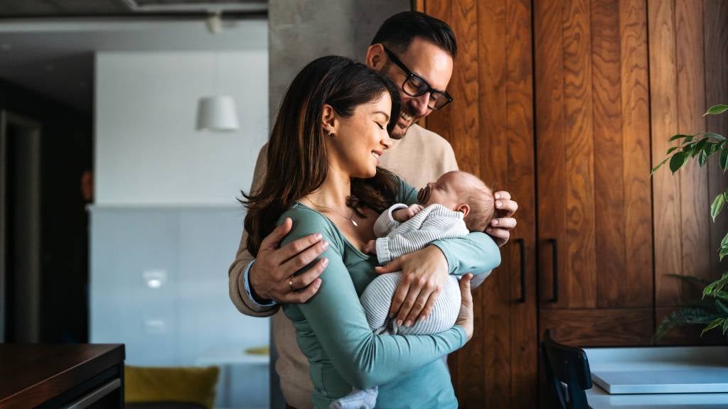 Parents hold their new baby