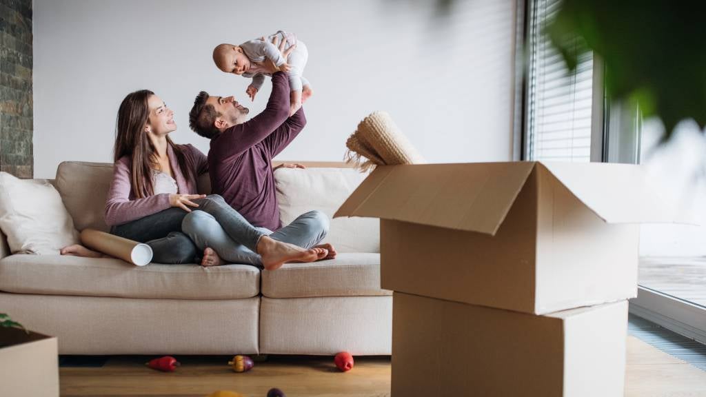 Young couple with baby in their new home