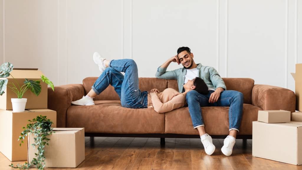 Couple relaxing on couch in new home