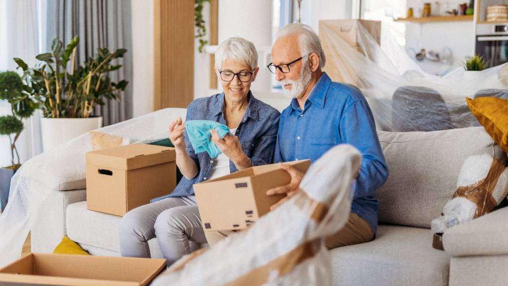 Man and woman packing boxes at home