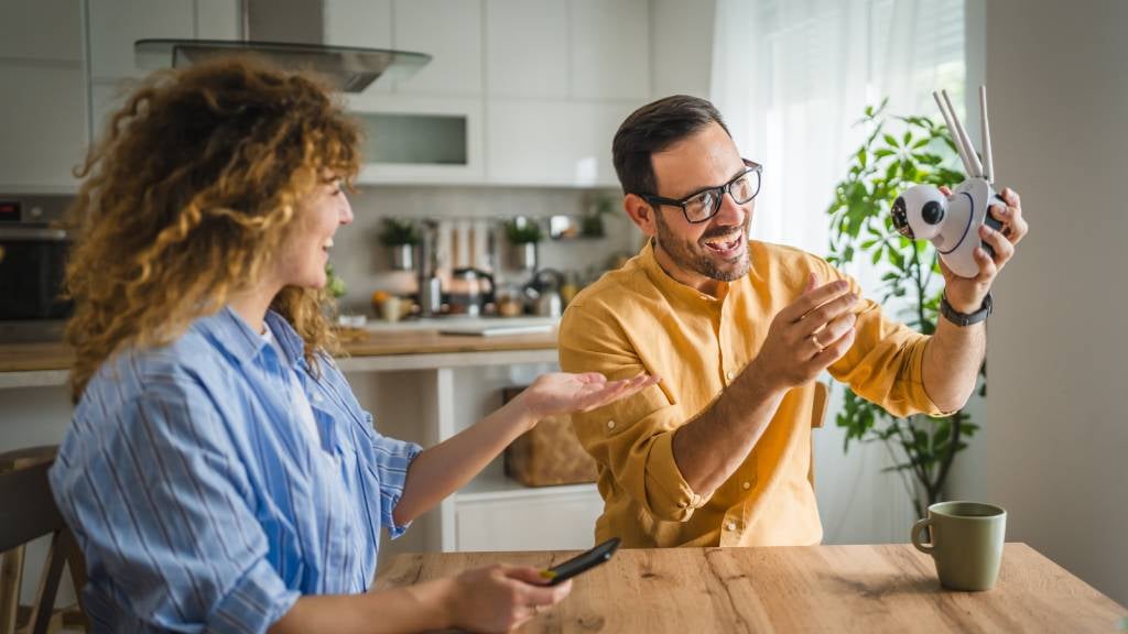 Couple look at home security camera system