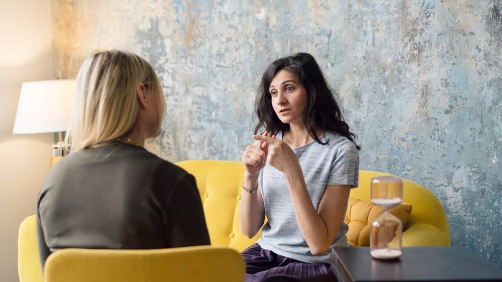 Woman psychologist talking to patient