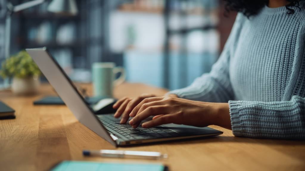 Woman typing something on her laptop