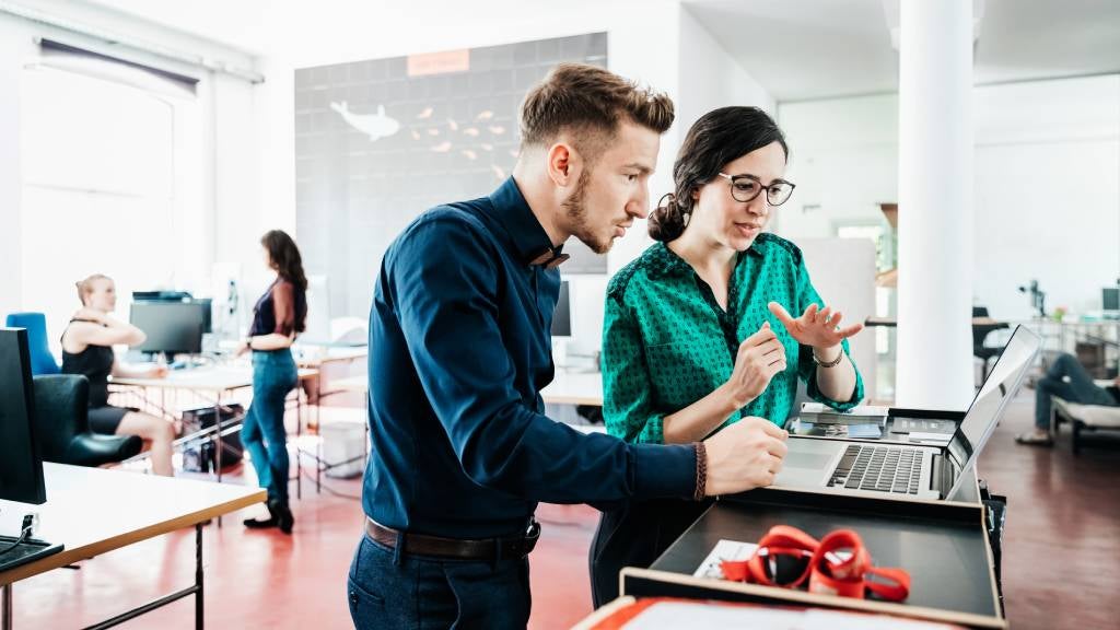 A group of start-up business employees working together in a modern office environment