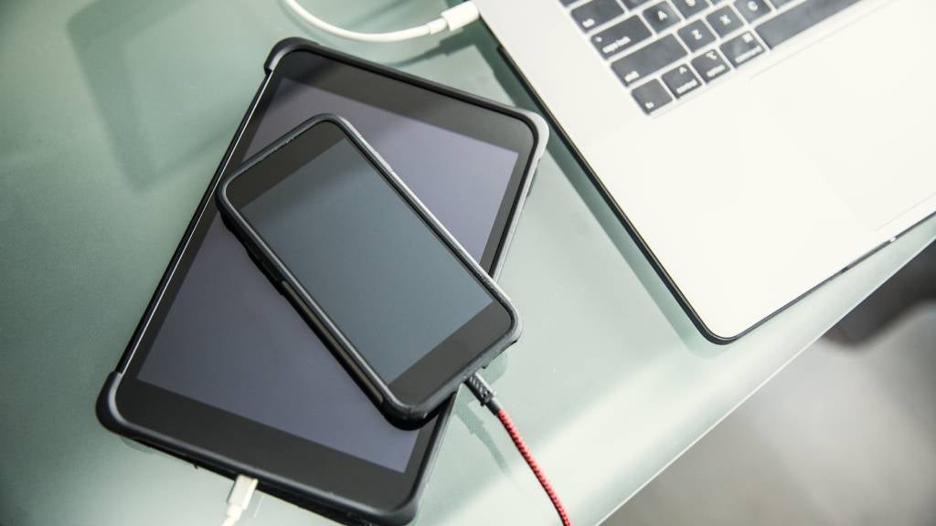 Mobile devices and laptop charging on office desk