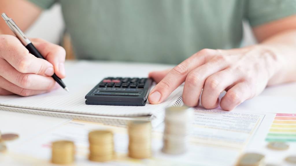 Man working out his finances on a calculator