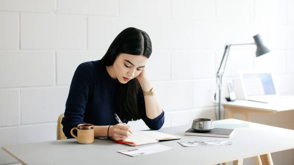 Young woman taking notes in a creative space