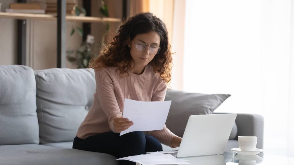 Woman looking worried as she assesses a document