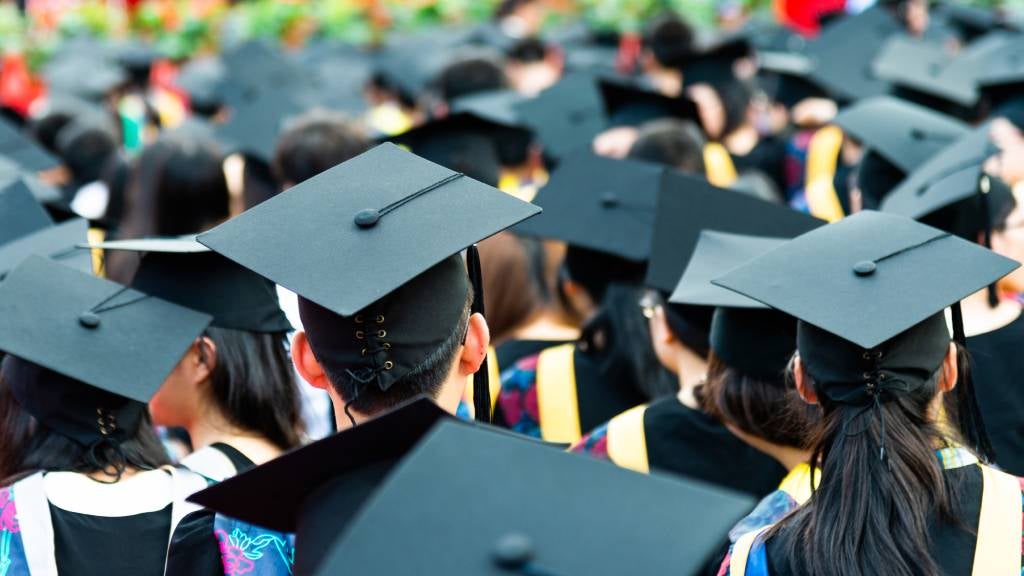 
Rear View Of Graduation Caps During Commencement