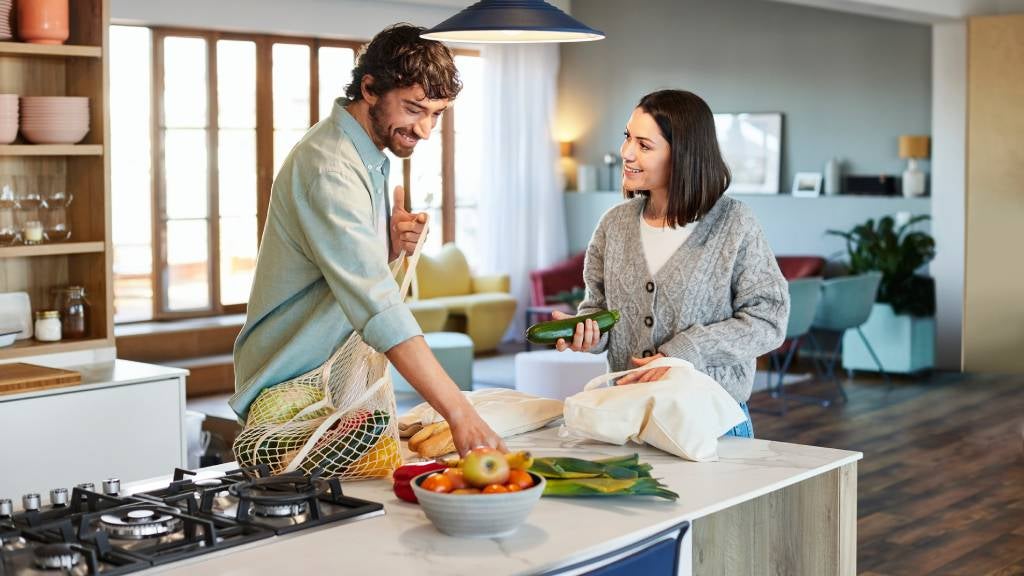 A happy couple preparing a meal in the kitchen