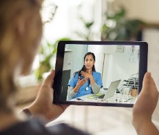Doctor on telehealth appoint with patient via tablet