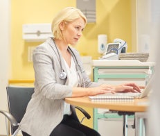 Female doctor sitting at desk working