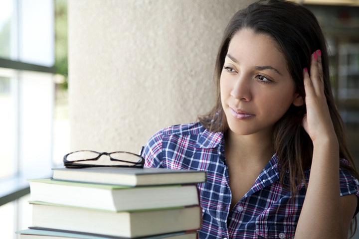 Female student sitting with her books