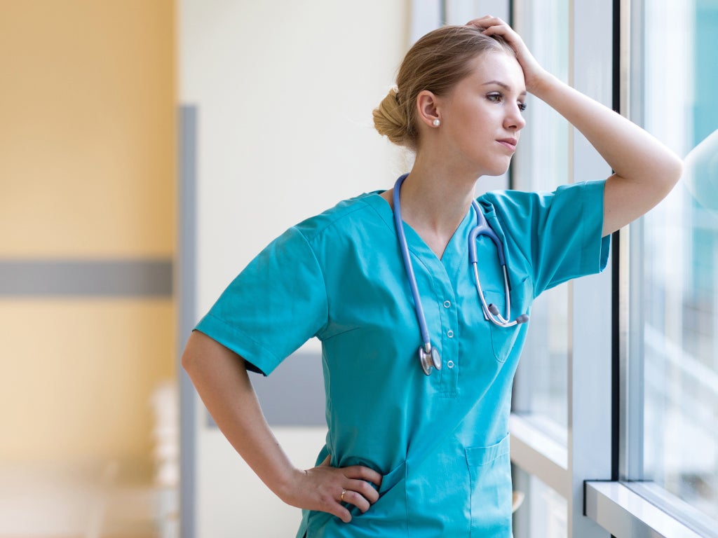 Medical professional female looking thoughtfully out window