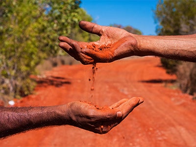 Hand in red sand