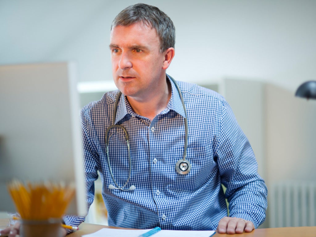 Doctor looking at file on computer
