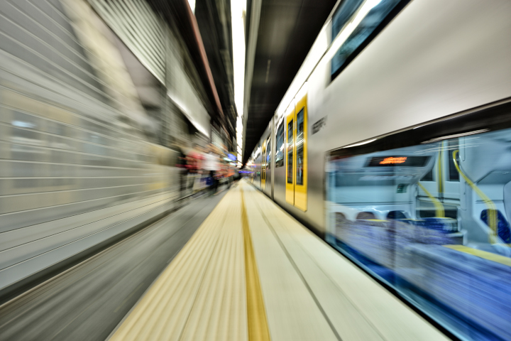Blurred image of trains going past station