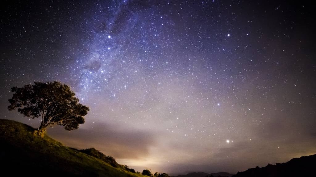 A starry night with hills and trees