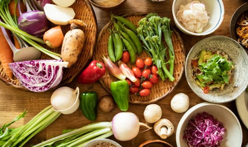 Colourful, healthy vegetables laid out on platters on a table. 