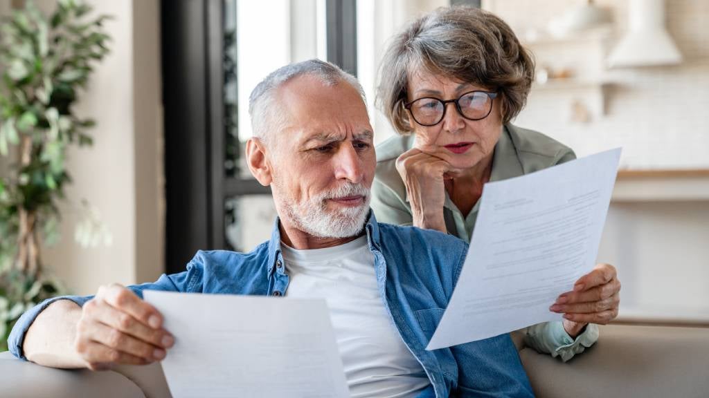 Senior man and woman looking at documents