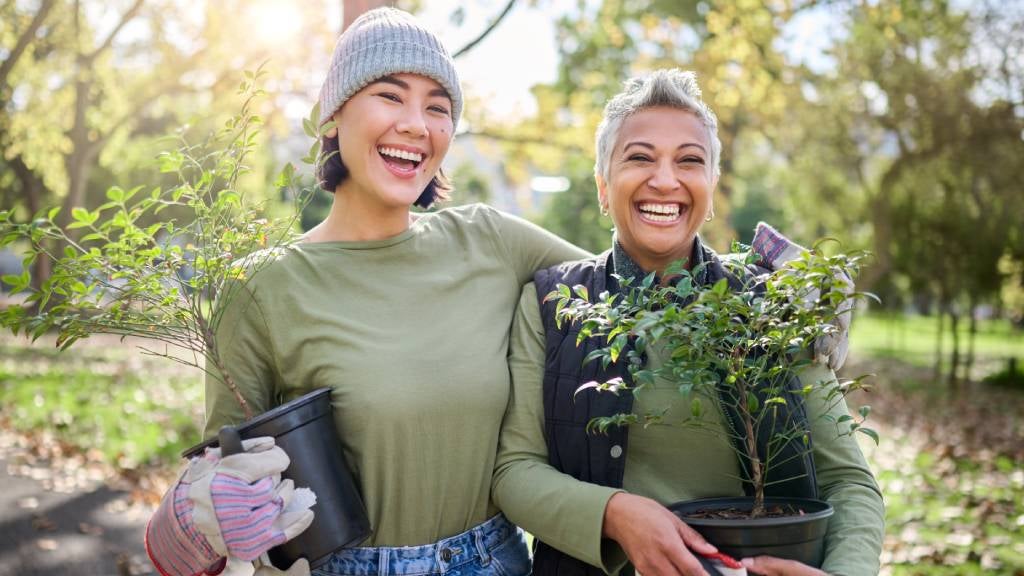 Two women planting trees