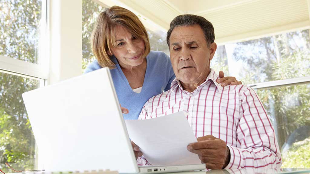 A man and a woman looking at a laptop.