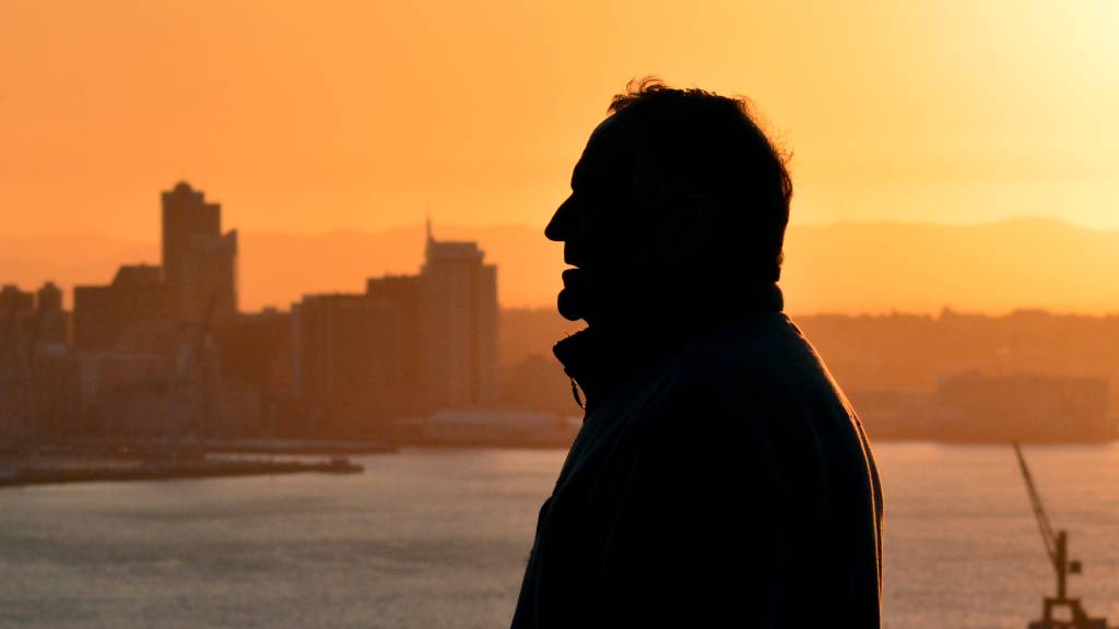 old man watching city in distance