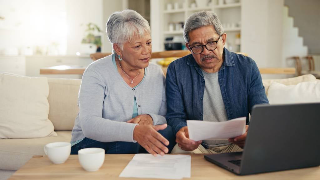 Senior couple with documents and laptop  